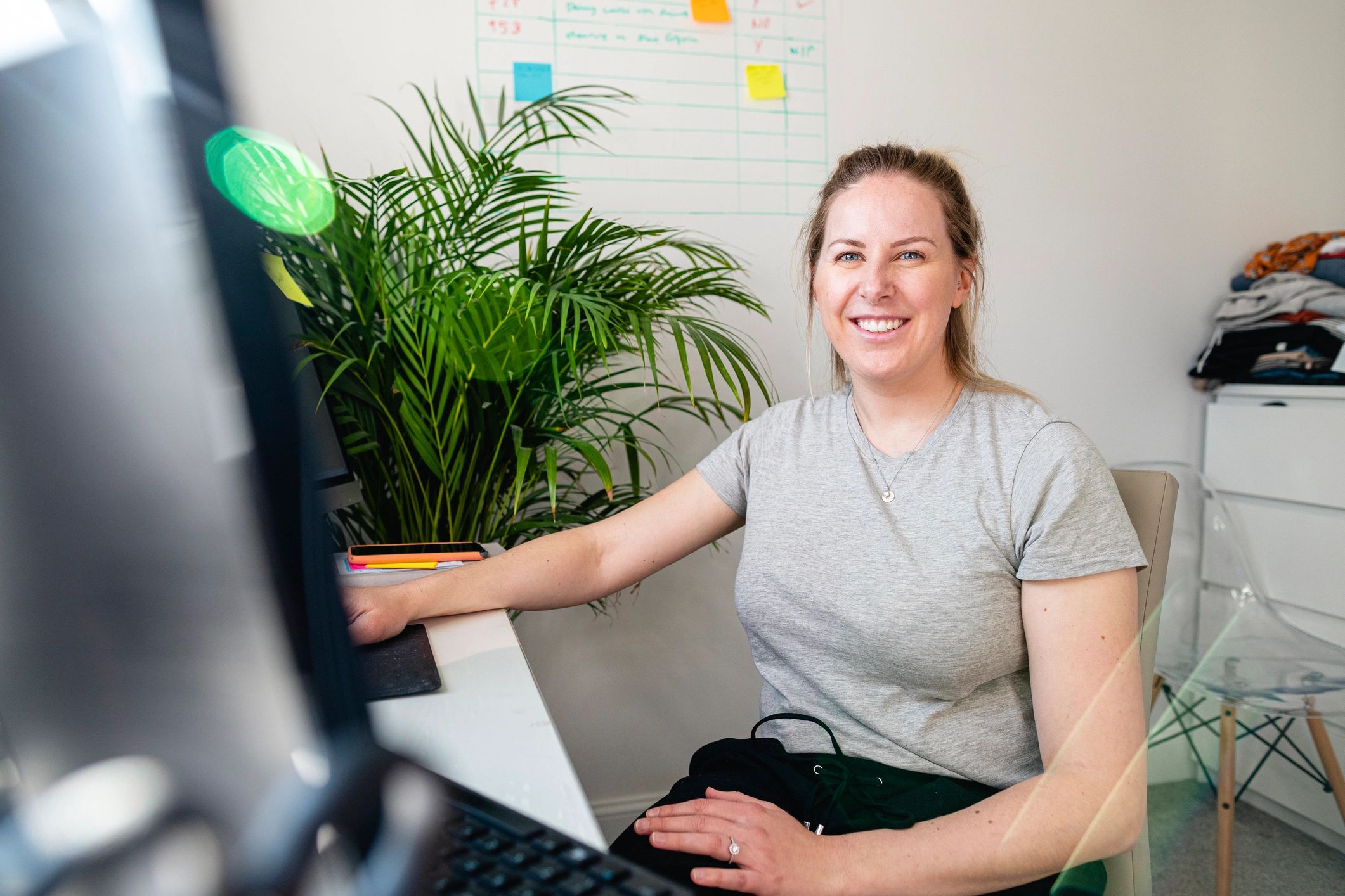 Smiling woman in a warm home office representing creative community and support